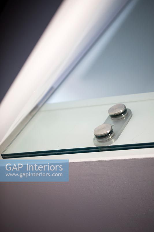 Detail of chrome knobs on glass cabinet doors 