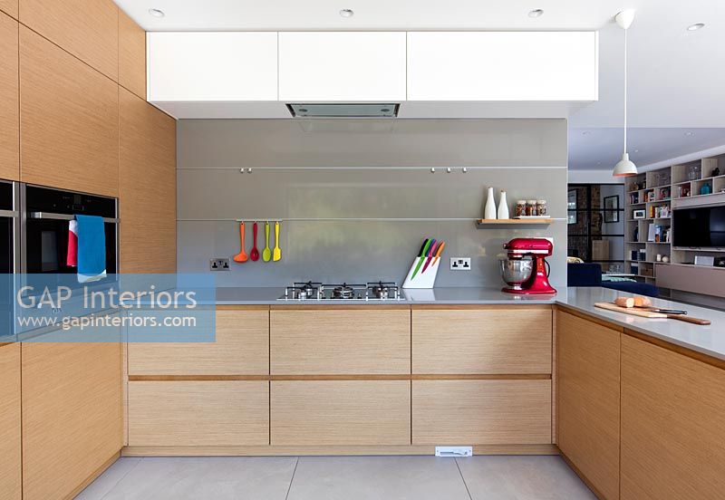 Modern kitchen with colourful utensils 