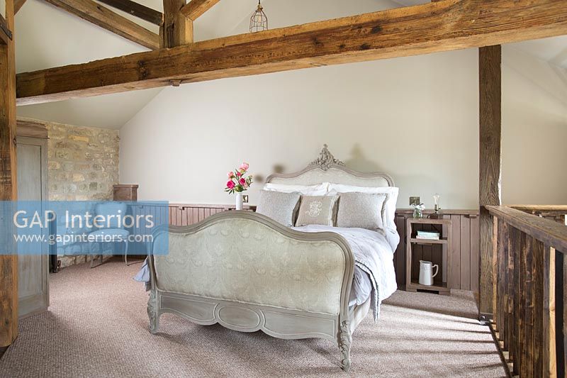 Classic bed in country bedroom 