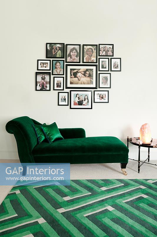 Green chaise lounge and display of photographs 