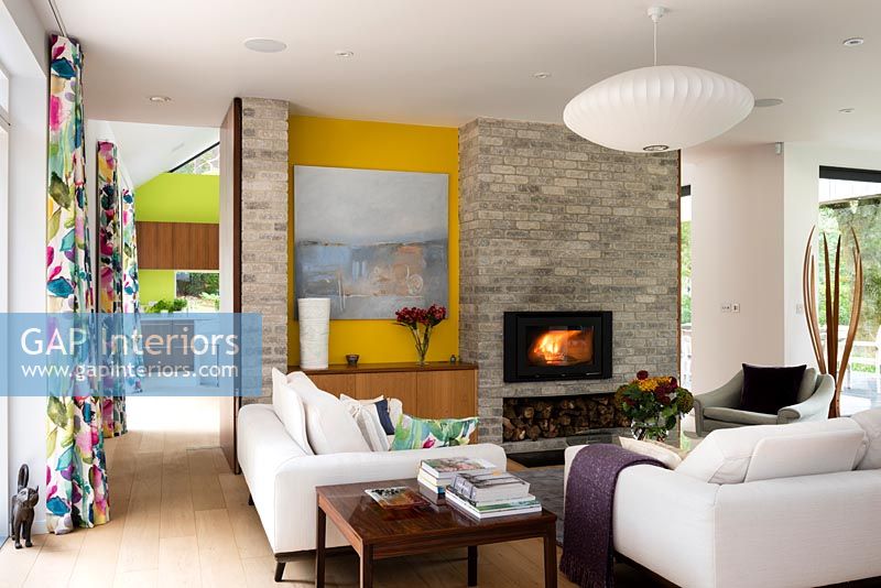 Contemporary living room with lit fire 