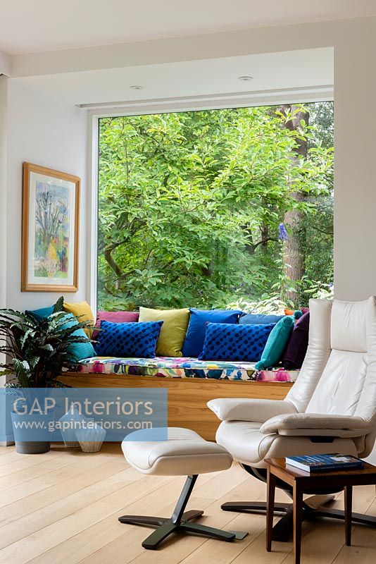 Colourful cushions on built in window seat 