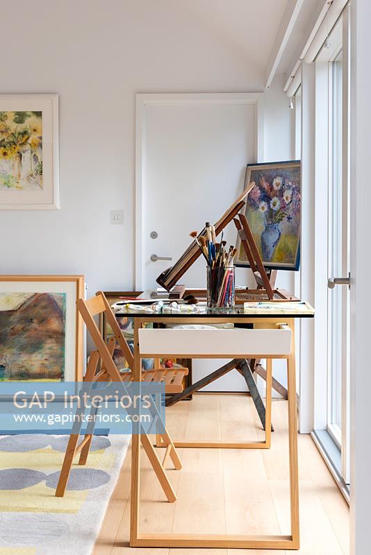Desk, paintings and artists equipment 