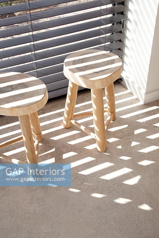 Wooden log stools bathed in sunlight  