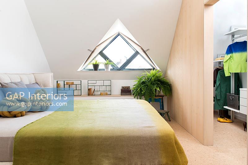 Modern bedroom with triangular window 