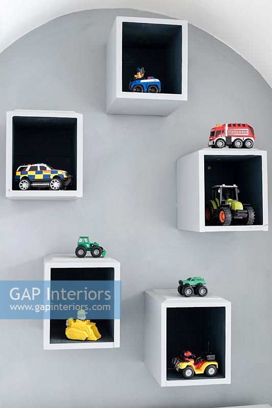 Box shelves with cars and toys displayed 
