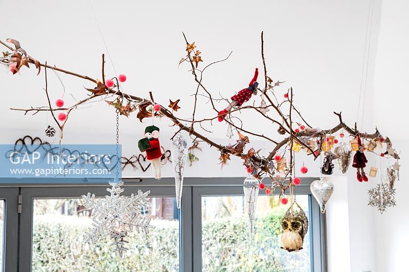 Branch above window decorated for Christmas 