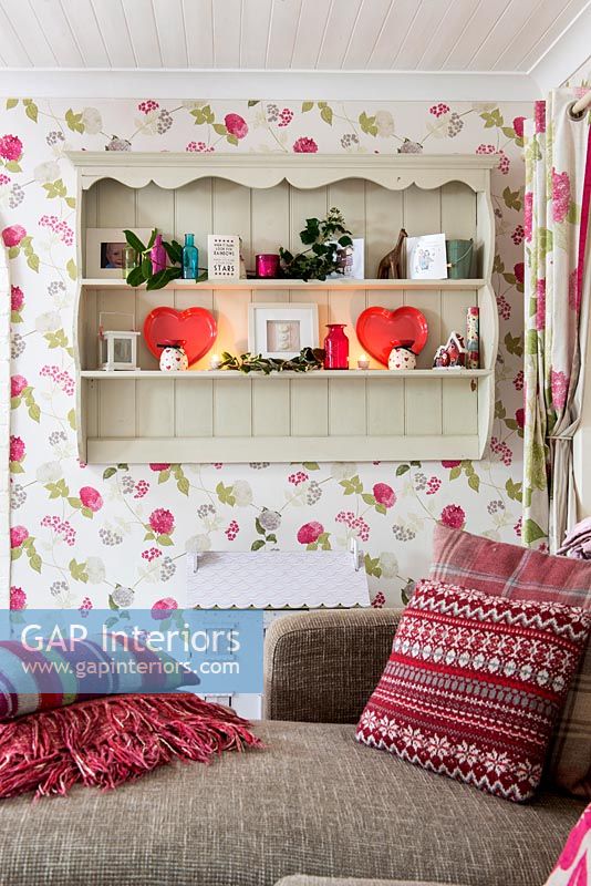 Floral wallpaper shelf unit in living room at Christmas 
