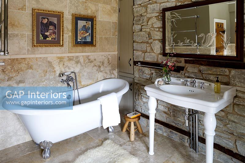 Country bathroom with exposed stone walls 