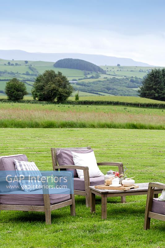Garden chairs with extensive countryside views beyond 