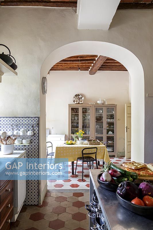 Country kitchen with archway to dining room