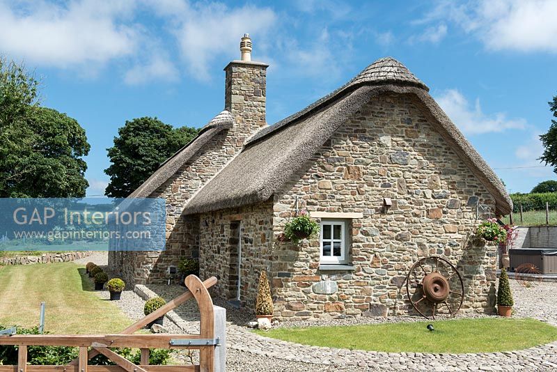 Exterior of a thatched stone cottage