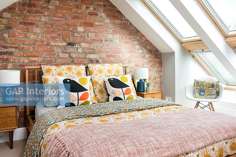 Modern bedroom with exposed brick wall