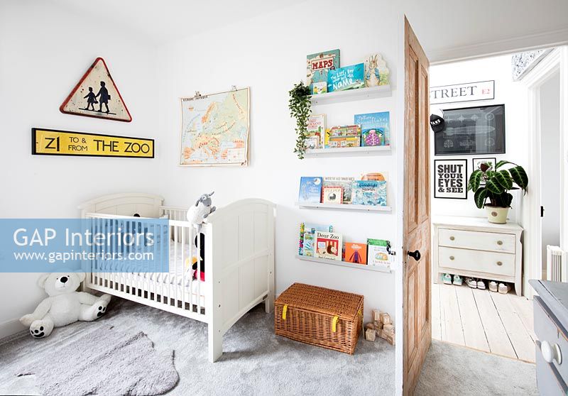 Modern nursery with cot and book shelves 