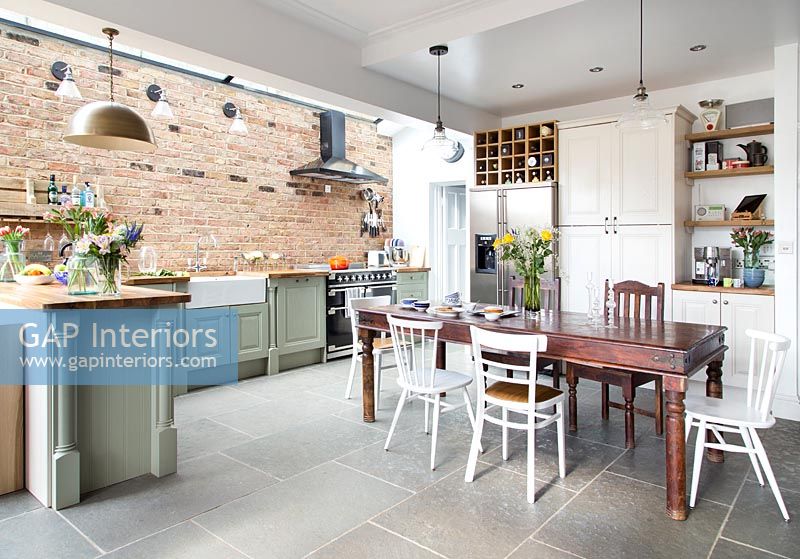 Large modern kitchen diner with exposed brick wall 