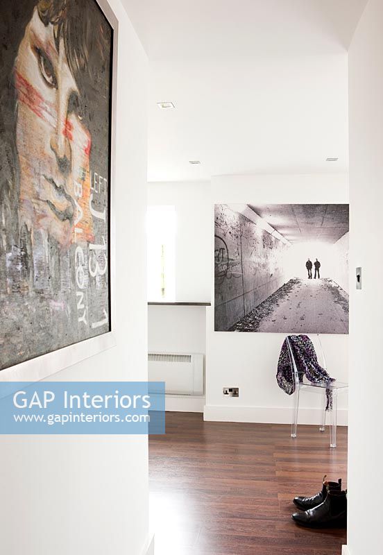 Modern artwork on walls of corridor and living space 