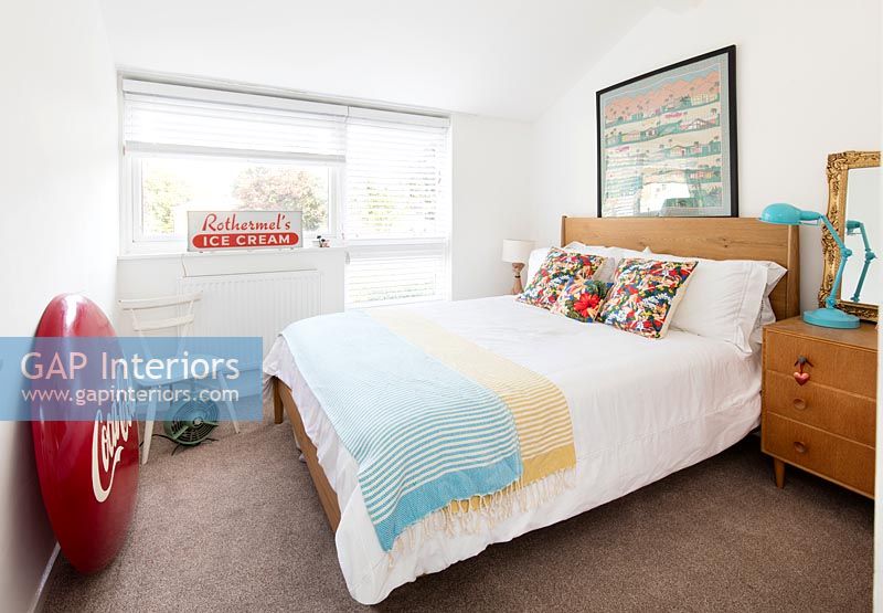 Colourful vintage items in modern bedroom 