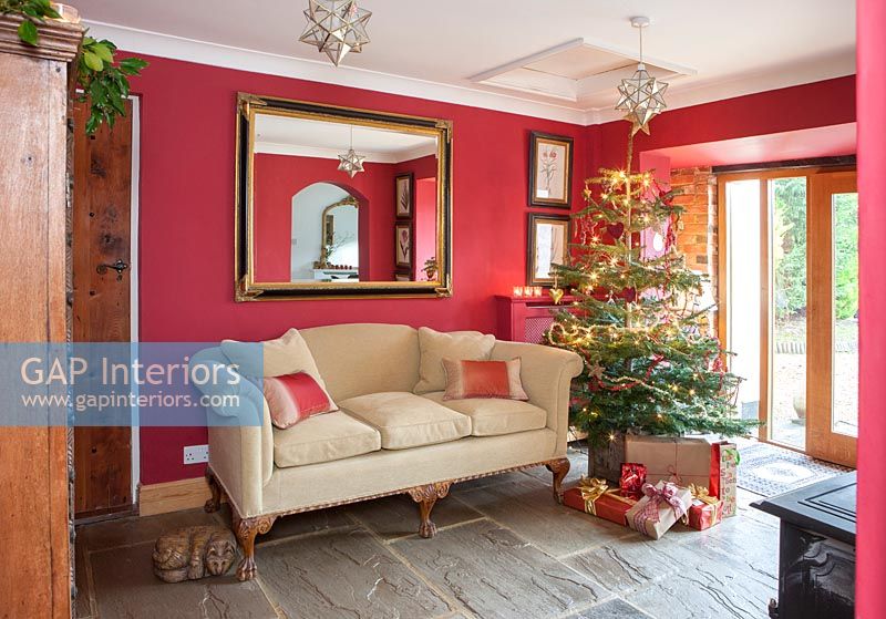 Red painted country living room decorated for Christmas 