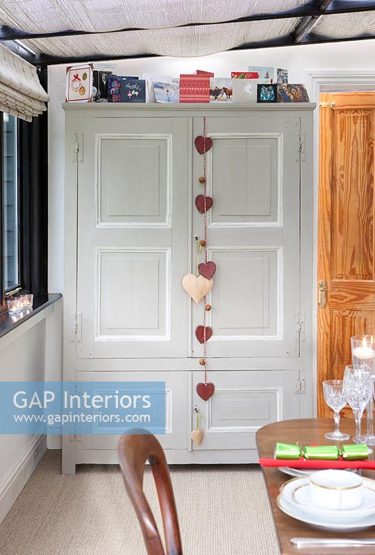 Heart decorations on large cabinet in dining room at Christmas
