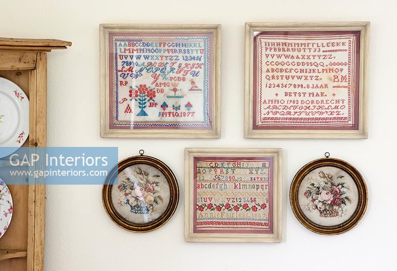 Small framed tapestries on wall display 