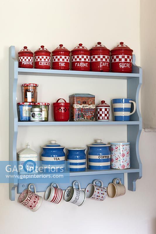 Display of storage jars on wall mounted shelf 