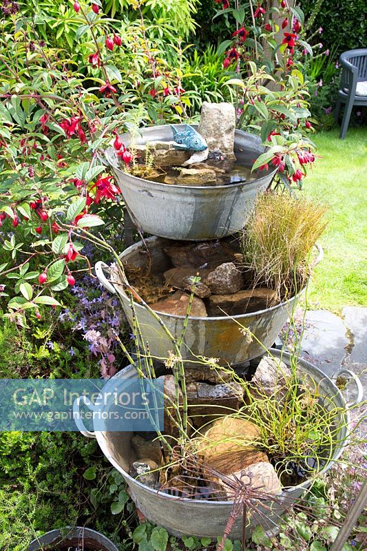 Homemade water feature made with vintage tin bowls 
