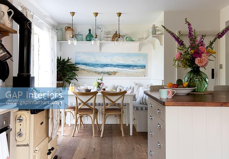 Coastal painting above dining table in modern country kitchen diner 