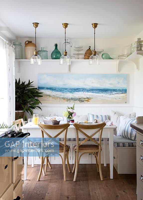 Coastal painting above dining table in modern country kitchen diner 