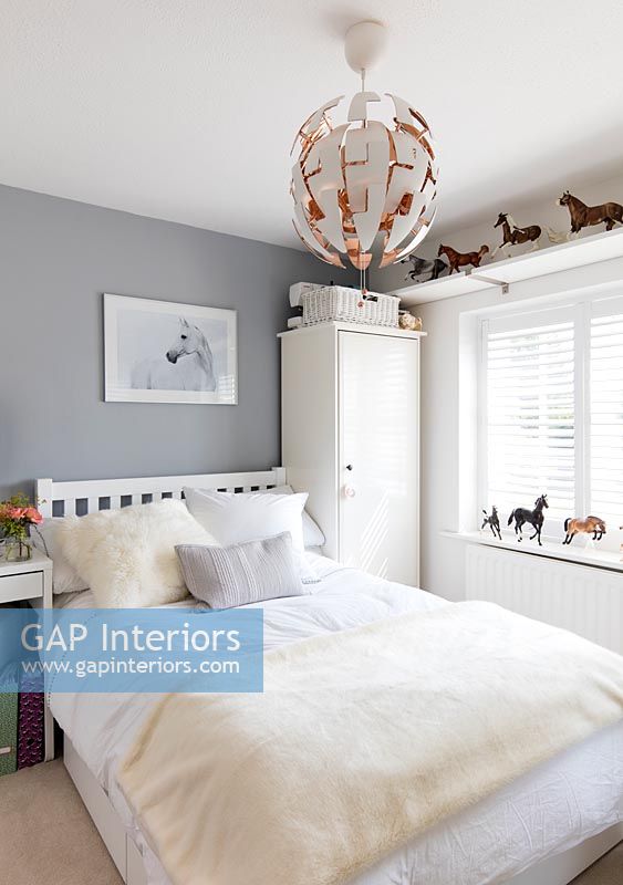 Grey painted walls and horse ornaments in childrens room 