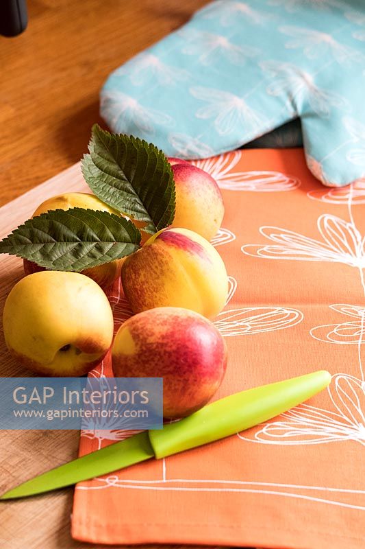 Nectarines and a knife on kitchen table 