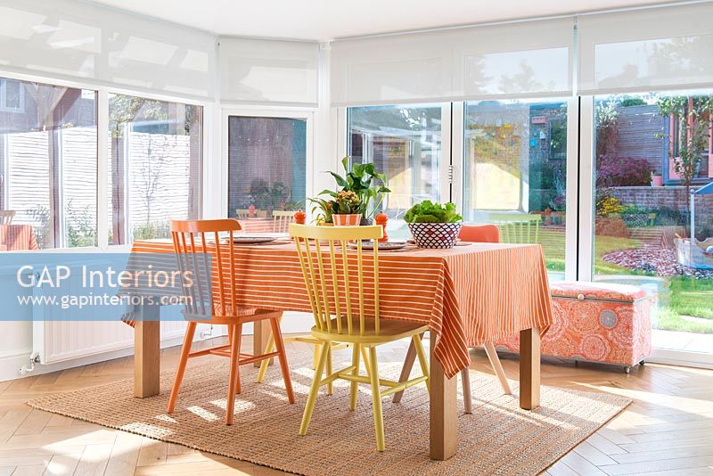 Orange and yellow furniture in modern dining room 