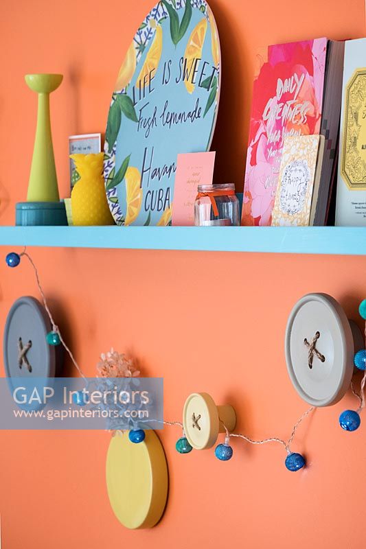 Colourful display of items on shelf and wall mounted button decorations