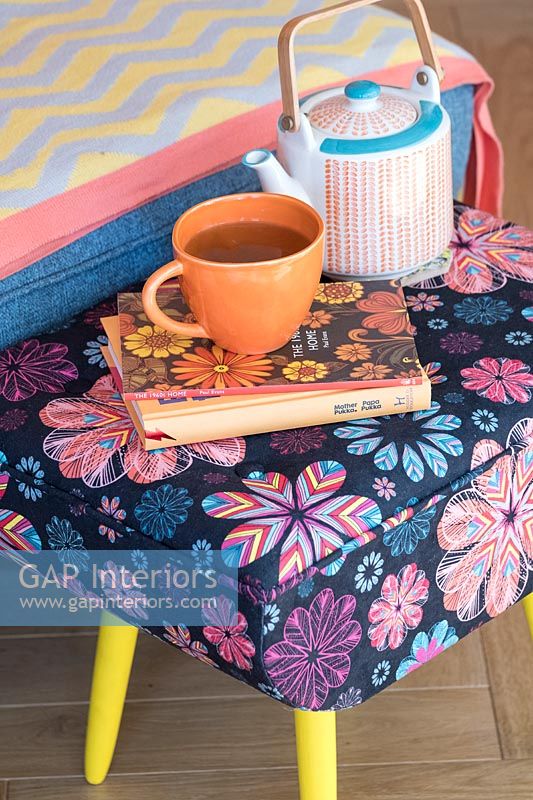 Colourful modern floral footstool with teapot and cup