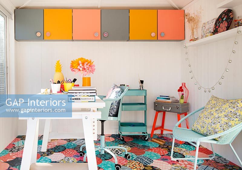 Colourful workshop with storage and desk 