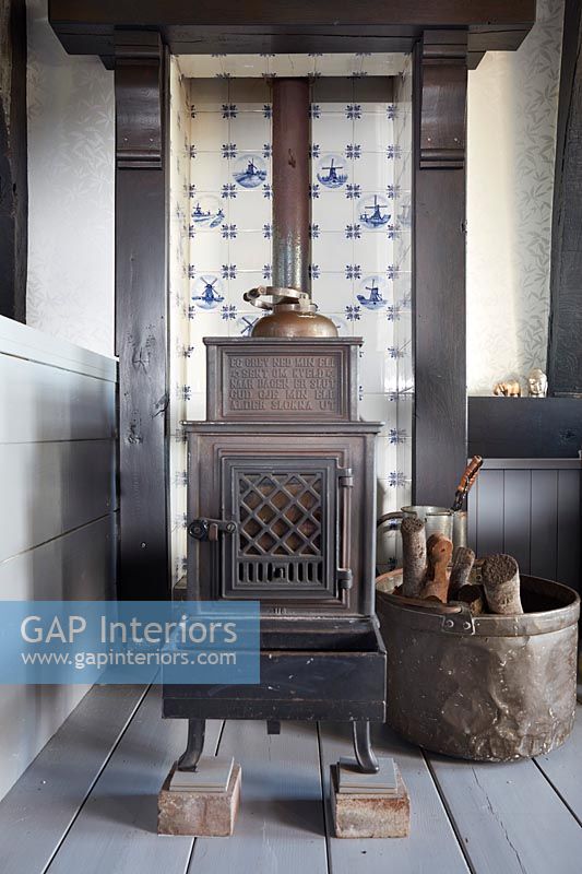 Dutch tiles in fireplace with wood burner 