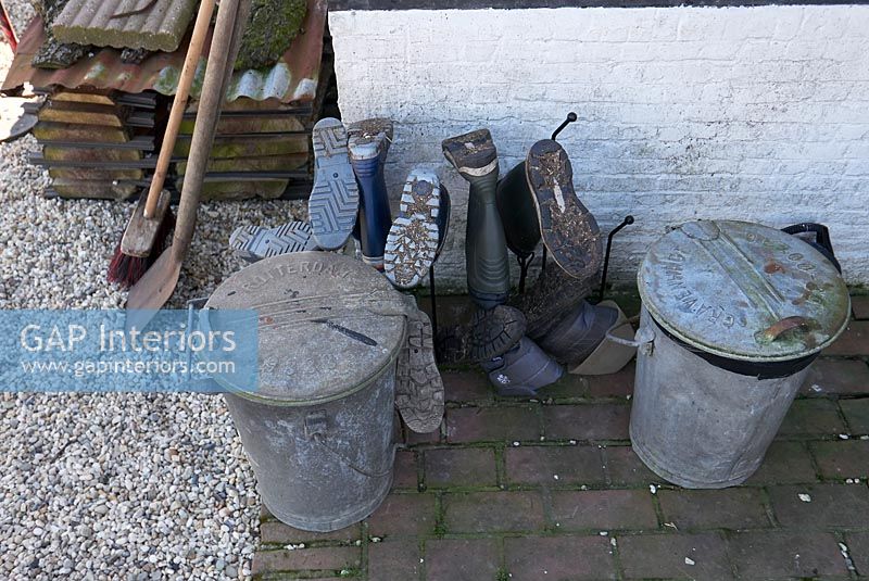 Wellington boots and old galvanized metal bins 