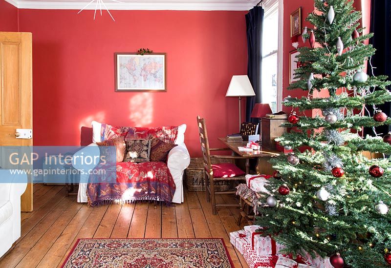 Classic living room with red painted walls at Christmas 