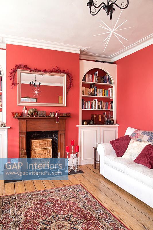 Classic modern living room with red painted walls and Christmas decorations 