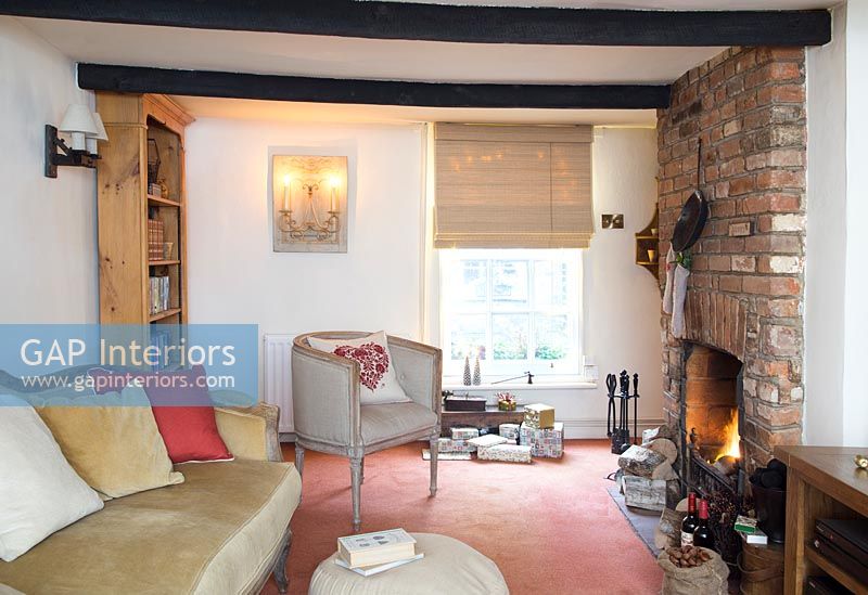 Cosy cottage living room with lit fire 
