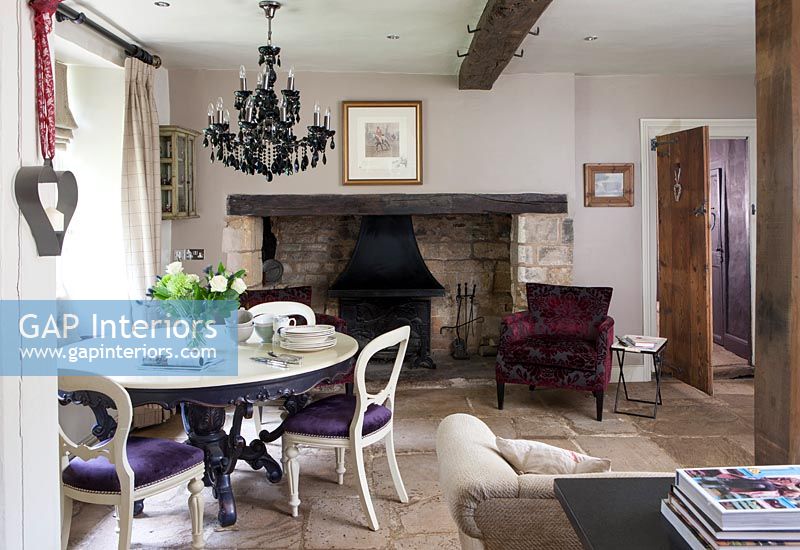 Purple upholstery on dining chairs in eclectic country dining room 
