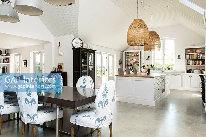 Modern country kitchen diner with fabric covered dining chairs 