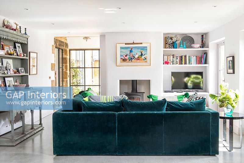 Modern living room with teal velvet sofa 