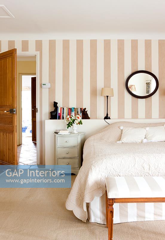 Modern country bedroom with striped wall paper 
