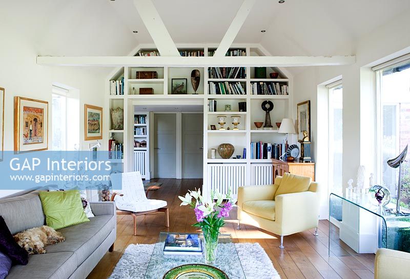 Modern living room with built in bookshelves around doorway 