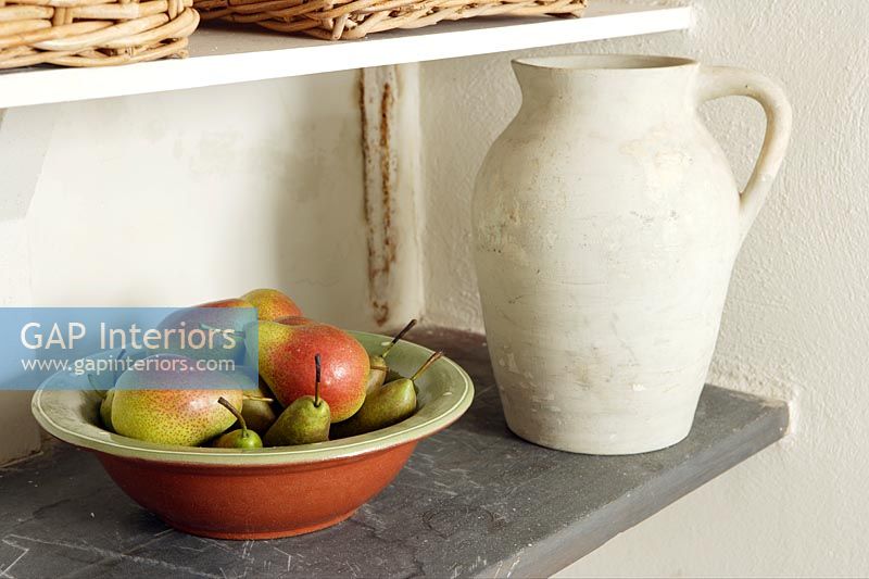 Jug and bowl of pears on shelf 