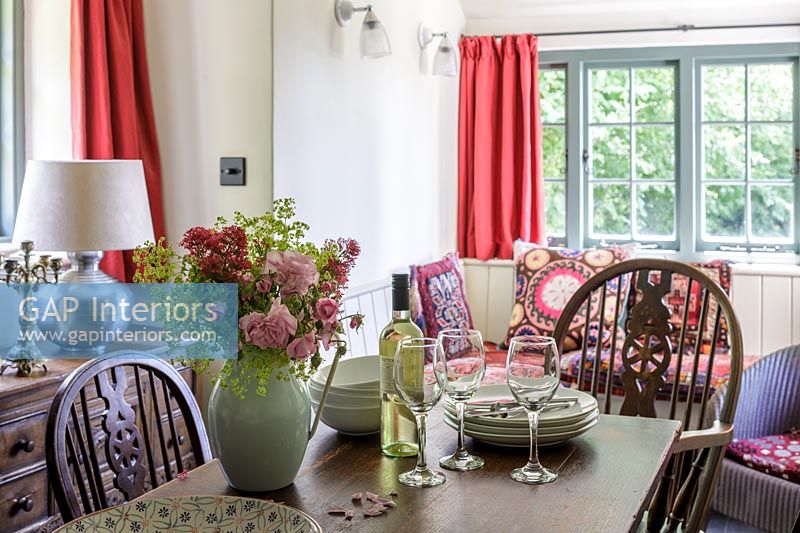Cosy dining area with table and chairs in Arts and Crafts country cottage