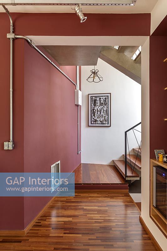 Hallway and stairs with dark red painted walls 