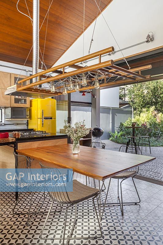 Modern industrial kitchen-diner with bifold doors to garden 