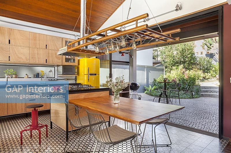 Modern industrial kitchen-diner with bifold doors to garden 