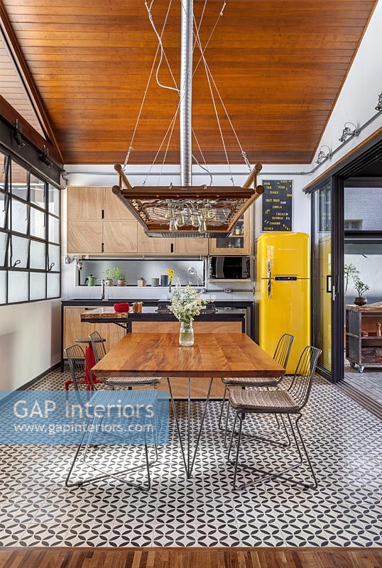 Modern industrial kitchen-diner with open sliding patio doors 